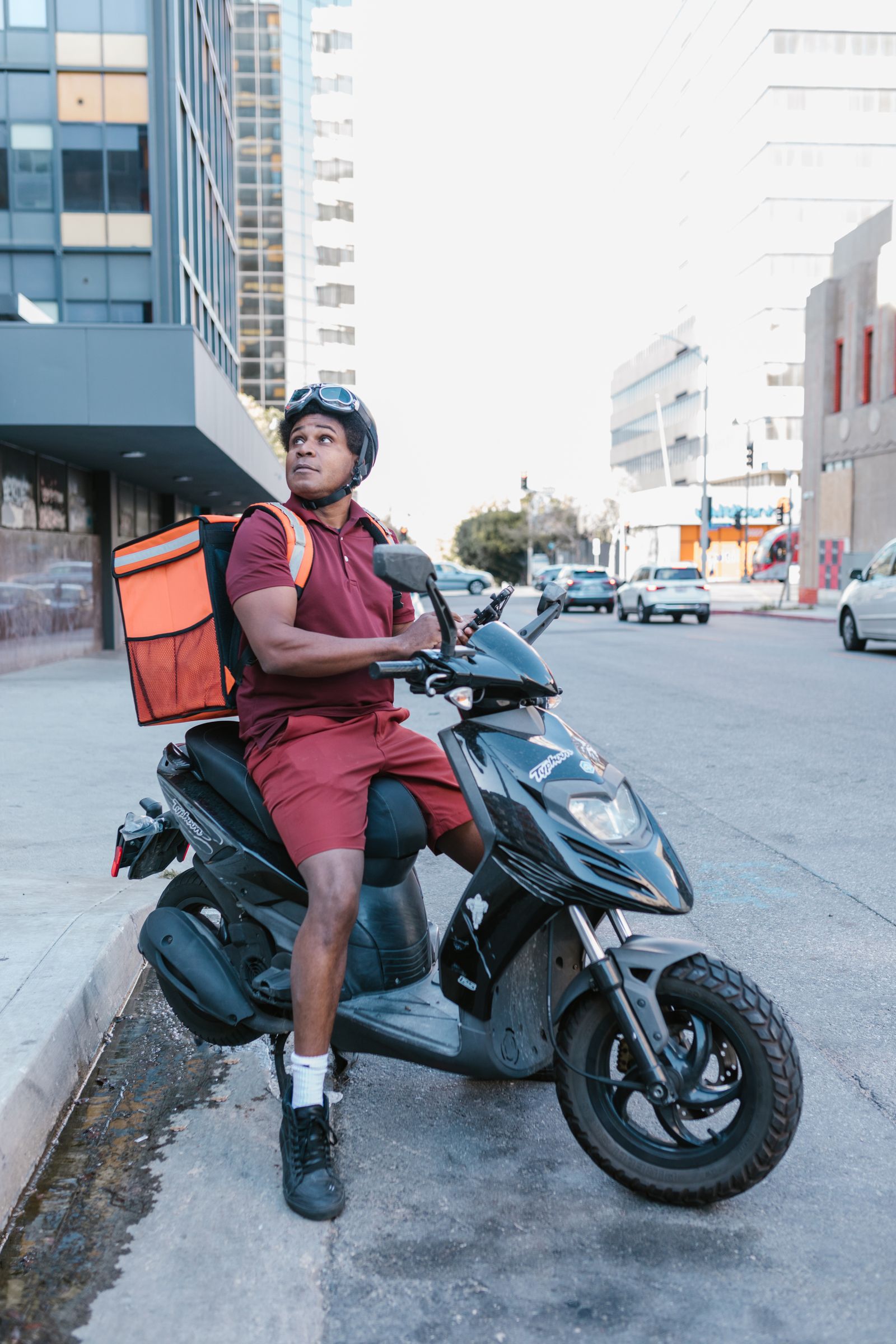 A rider with an insulated delivery bag on the road